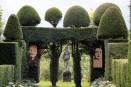 relief carving portraits amongst topiary