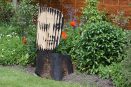 burnt oak lines stencil face sculpture art garden